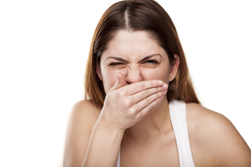 woman covering teeth in need of Oak Brook chipped tooth repair