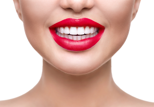 ealthy white smile closeup. Beautiful girl with red lips isolated on white