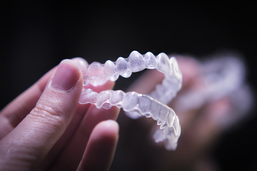 Woman hand holding invisible orthodontics