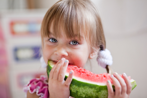 child eating watermelon