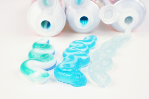 Three types of toothpaste in tubes closeup.