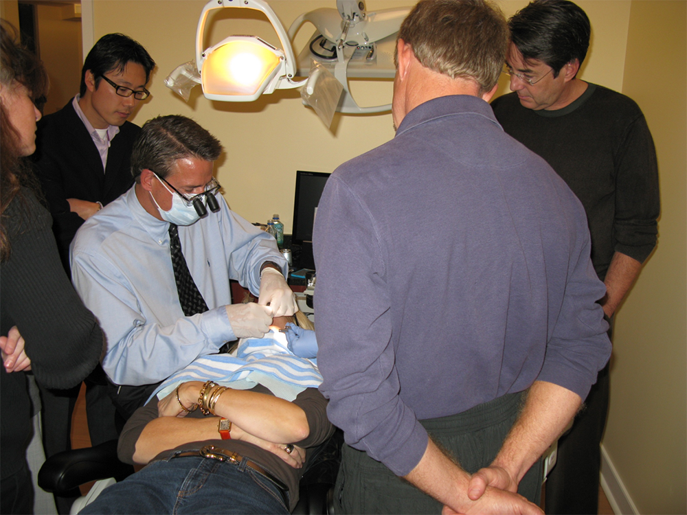 Dr Harnois performing dental treatment as training