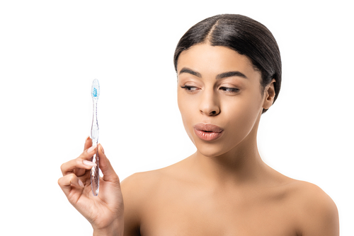 woman holding up a tooth brush