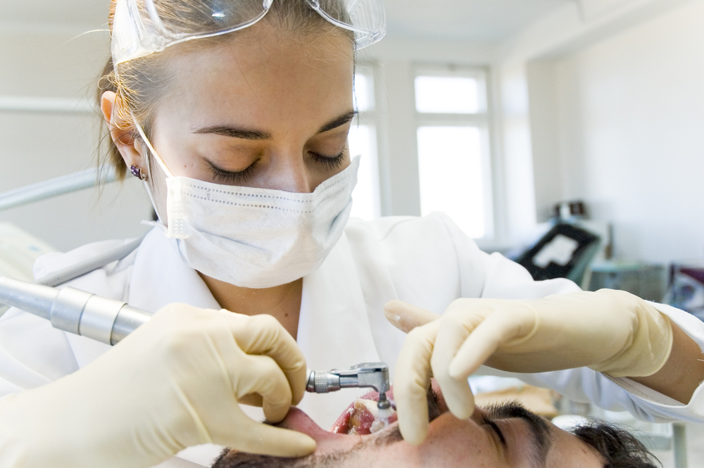 female dentist treating patient