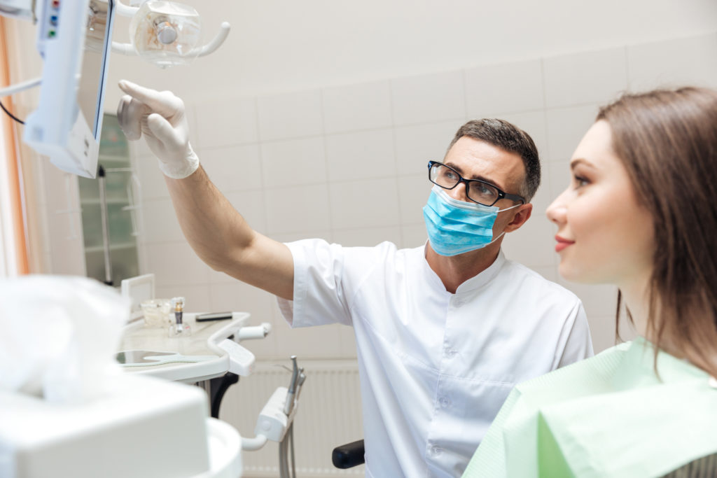 Dentist showing patient digital images of teeth