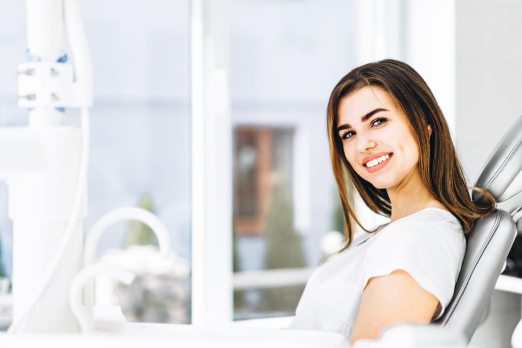 Woman with a healthy smile looking comfortable at the dentist