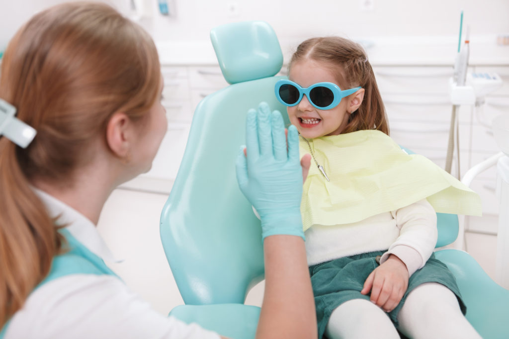Happy little girl at laser dentists office