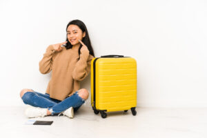 Young woman preparing for a vacation packing Invisalign.