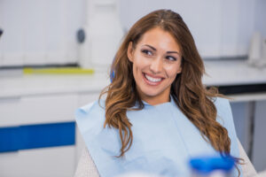 Smiling dental patient after tooth whitening.