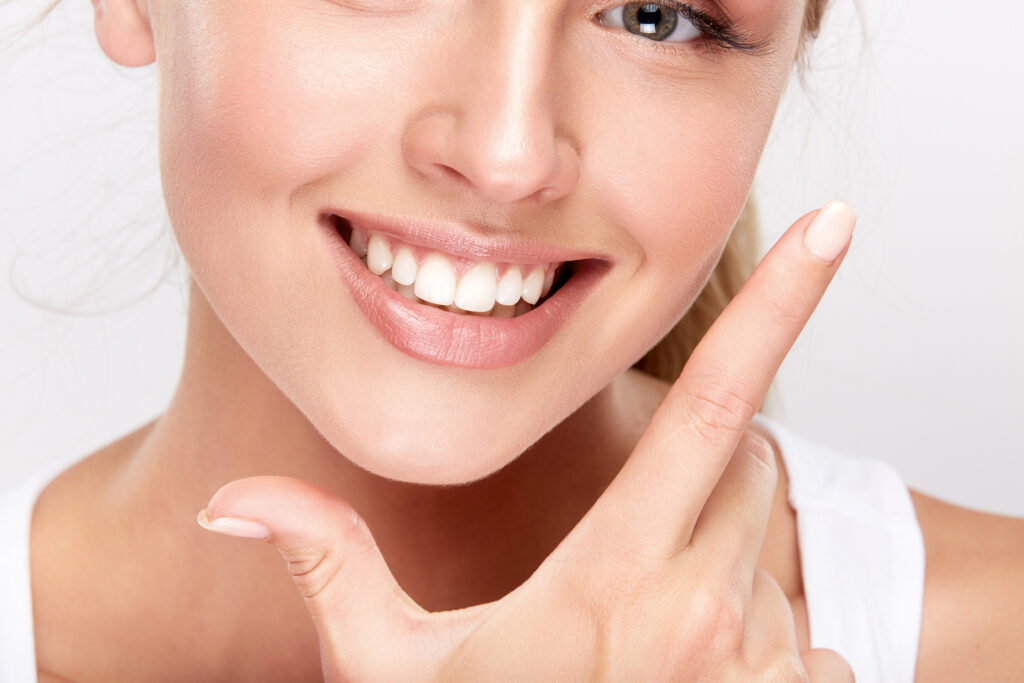 Woman showing off lumineers smile. 