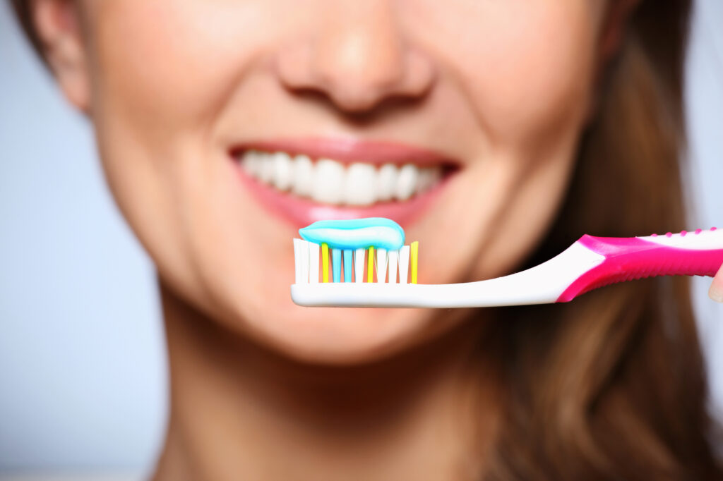 Woman brushing teeth in the morning. 