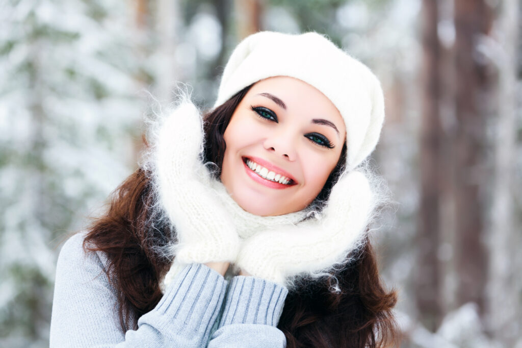 Woman outside in winter with bright, white teeth
