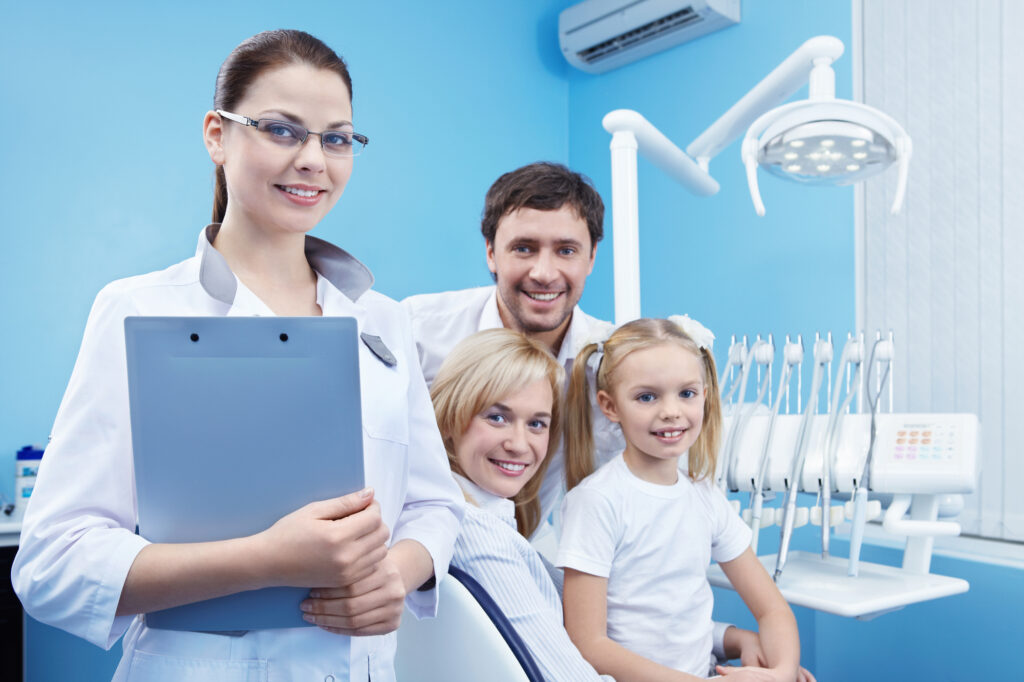 Family smiling at the dentist office. 