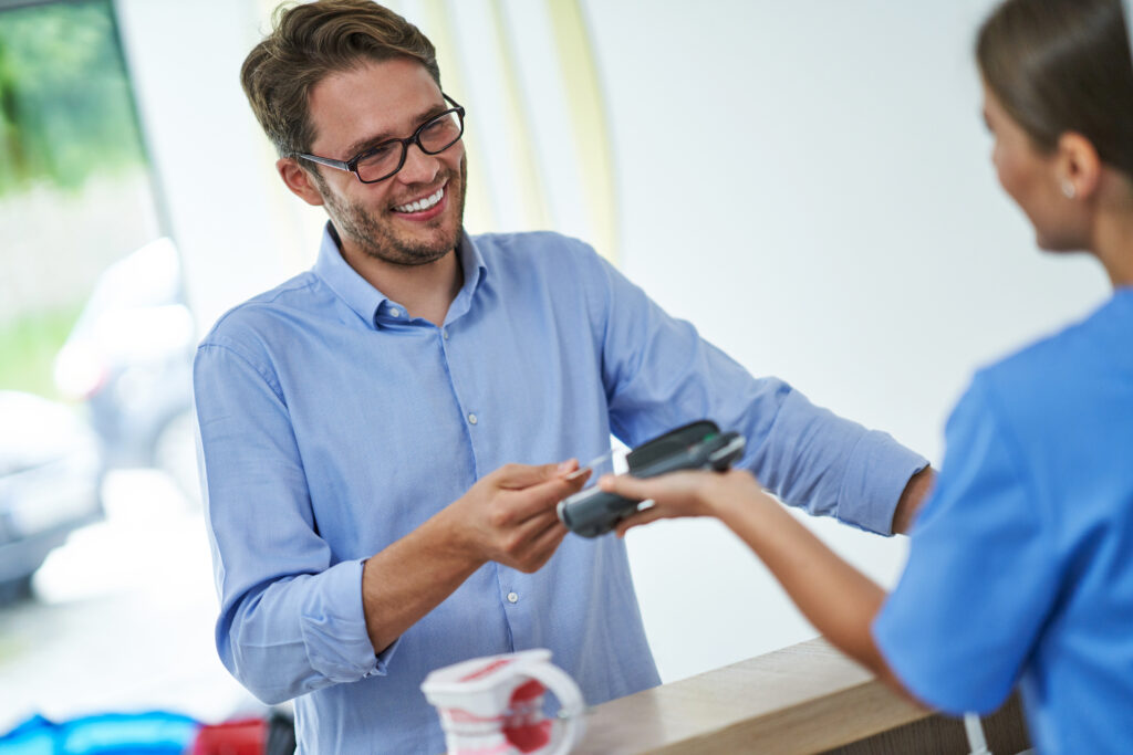 Patient paying at dental office with HSA card.