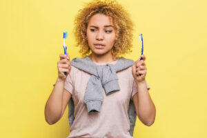 Woman choosing between toothbrushes