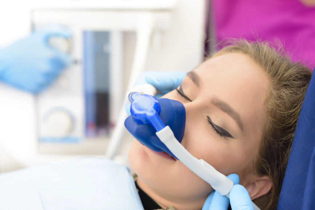 Woman at dentist using nitrous oxide laughing gas