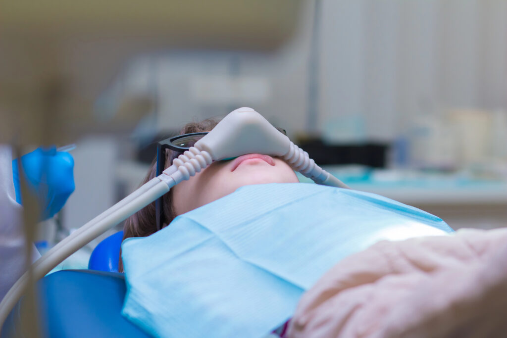Patient in dentist office comfortably sedated with nitrous oxide. 