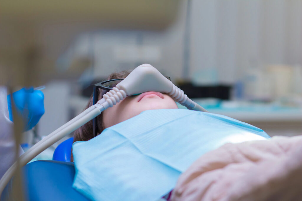 Patient in dentist office comfortably sedated with nitrous oxide.