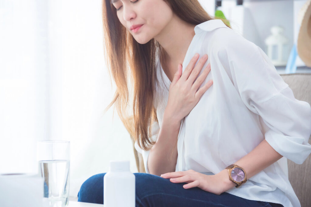 Woman with acid reflux pain. 